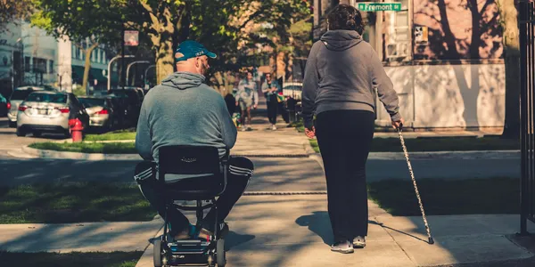 Person riding a mobility scooter outdoors