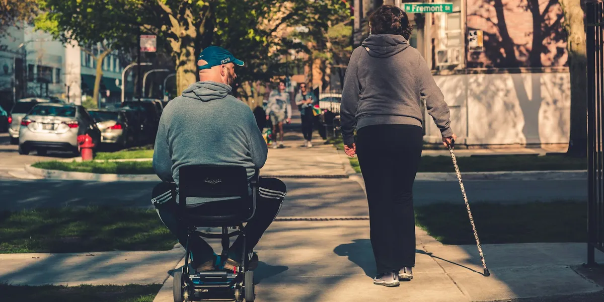 Person riding a mobility scooter outdoors