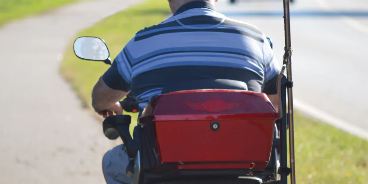 Person riding a mobility scooter outdoors